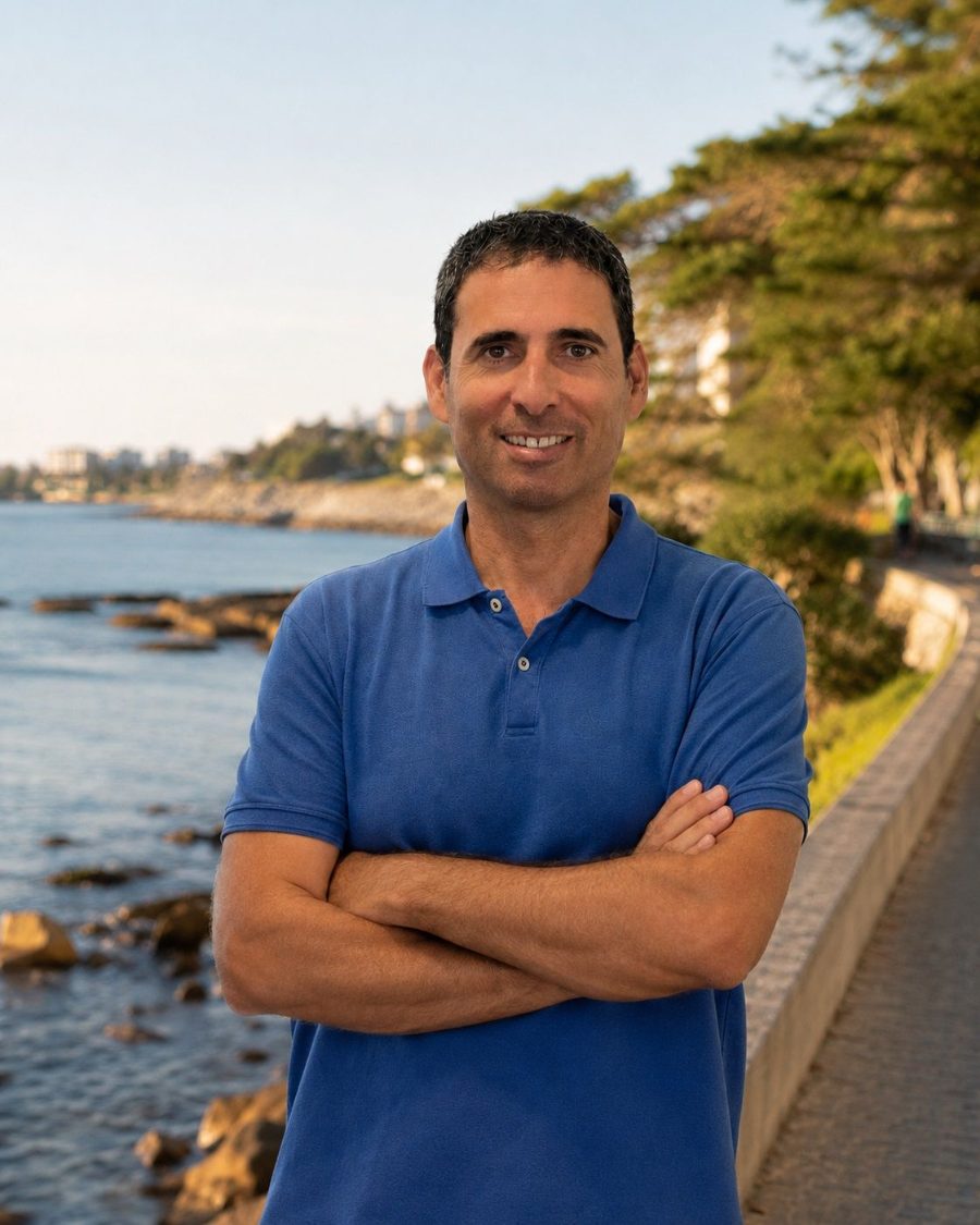 Ron Pollachek, standing on the oceanfront walkway in Victoria, British Columbia